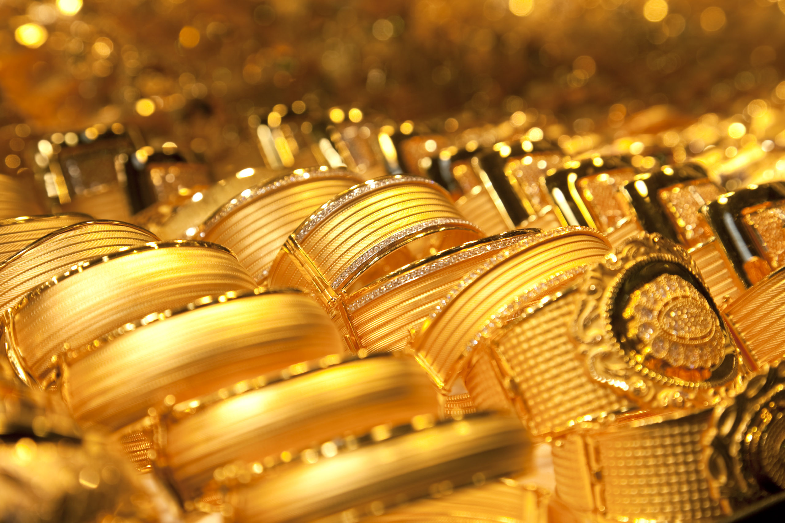 A close-up photo of numerous identical gold rings sitting side-by-side