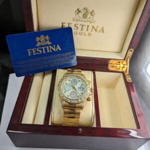 The 18K gold diamond Festina chronograph watch in its original wooden presentation box with the warranty card.