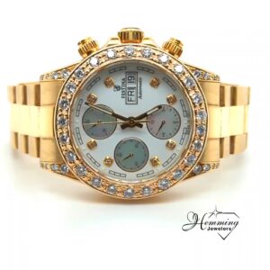 Front view of a diamond-set 18K gold Festina automatic chronograph wristwatch with a white mother-of-pearl dial.